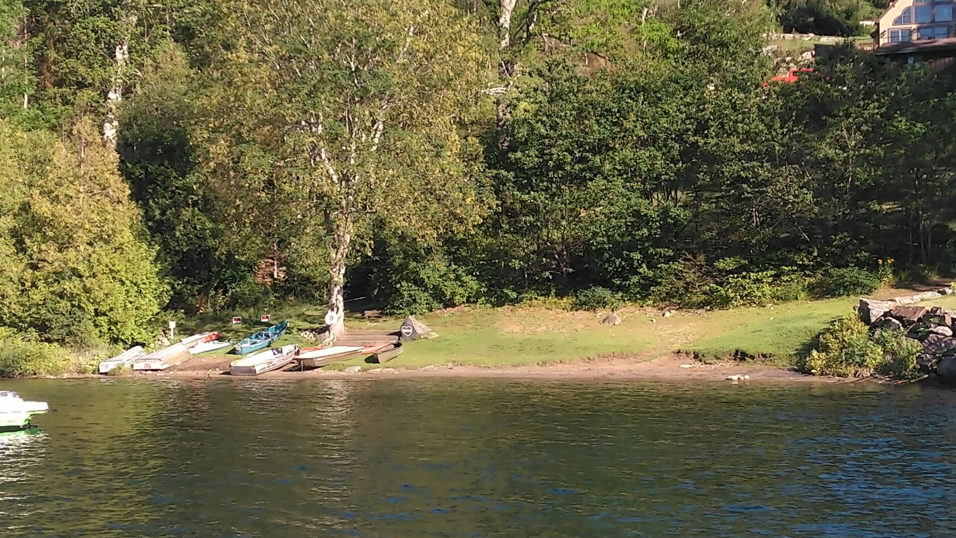 view of lake and shore with rowboats